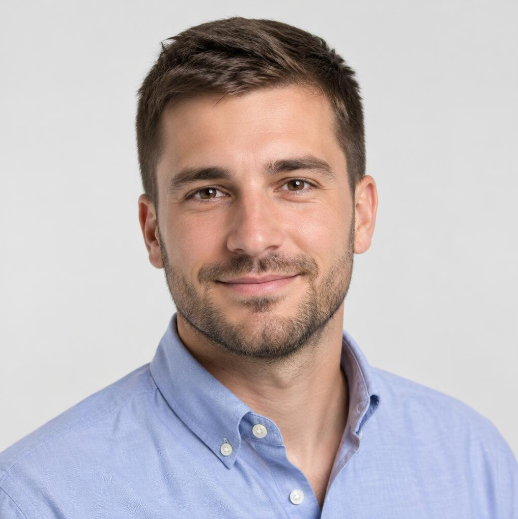 Portrait of a young man with short brown hair and a light beard